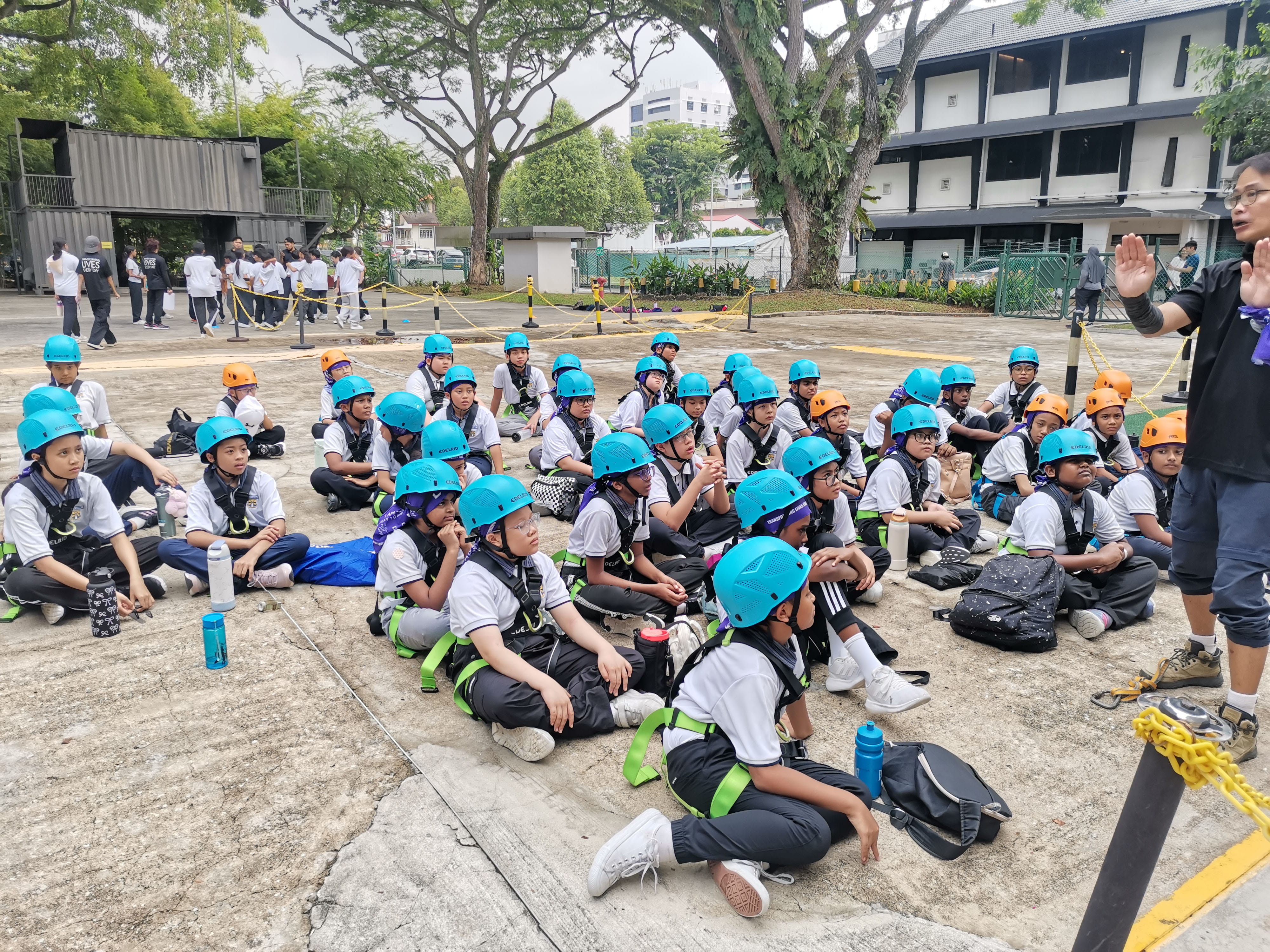 Helmets on and focused for the safety briefing before the climb